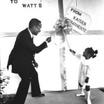 Center Director Bill Coggins and Annabell Ratcliff, 4, untie the bow to officially open the Watts center’s new building, 1977. LA Public Library photo